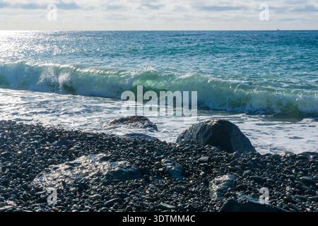 Beautiful seascape with waves breaking on the rocky shore. Stock Photo