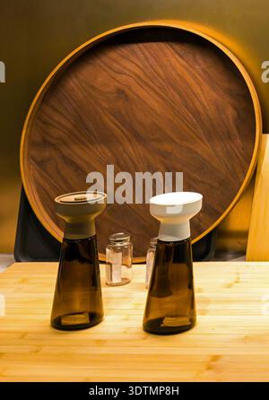 Two amber glass bottles with grinder tops used as a salt and pepper mill set Stock Photo