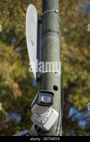 Security camera on a pole in a public area Stock Photo