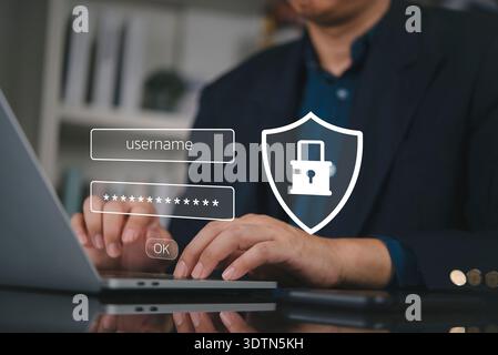 Businessman hand typing laptop, secure login password. Cybersecurity technology concept. Data protection, privacy, network access, shield icon. Accoun Stock Photo