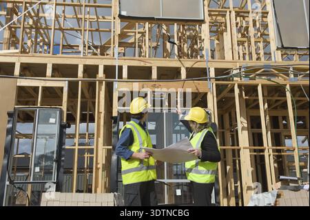 Civil engineer and worker discussing issues at the construction site Stock Photo