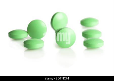 Group of green pills on white background Stock Photo
