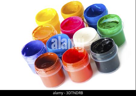 Set of used multicorored watercolor paint in opened containers on white background. SDOF Stock Photo