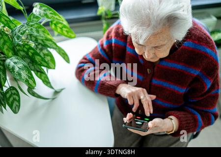 Senior facing phone scams and digital safety. Senior facing phone scams and digital safety. Digital literacy. model released Stock Photo