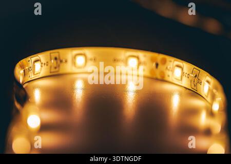 Warm white LED strip light macro close-up forming circular modern lighting background Stock Photo