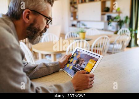 Man using smart home control panel. Man using smart home control panel, adjusting temperature. model released Stock Photo