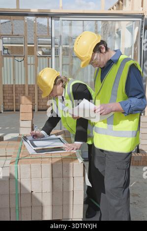 Civil engineer and worker discussing issues at the construction site Stock Photo