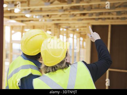 Civil engineer and worker discussing issues at the construction site Stock Photo