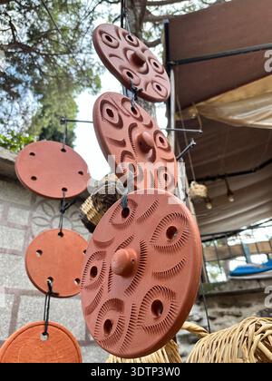 Handmade earthenware lids hanging on a string Stock Photo