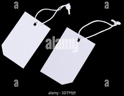 Blank paper Tags with White String isolated on black background. Stock Photo