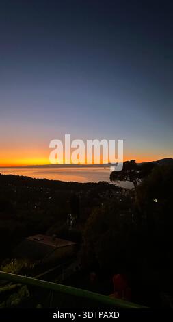 Dark deep blue gradient sunset sky over calm sea or lake peaceful dusk atmosphere Stock Photo