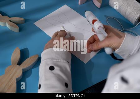 Making Easter bunny rabbit from cotton rope Gift Easter idea. Do it yourself instruction postcard eco-friendly decoration. Making handmade art presents children's diy projects. Spring holiday family time. Creative activity  Stock Photo