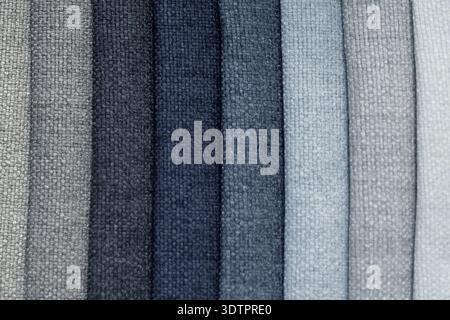 Fabric swatches displaying woven textures in varying shades of petrol blue and grey. These upholstery materials are aligned vertically, highlighting t Stock Photo