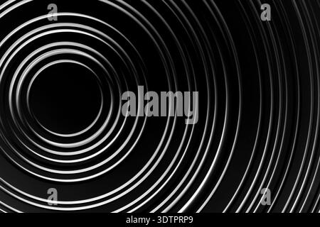 image is white circle on black background. circle is surrounded by series of smaller circles, creating sense of depth and movement Stock Photo