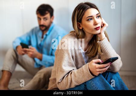 A couple quietly drifts past each other in daily life, showing emotional distance, fading connection Stock Photo