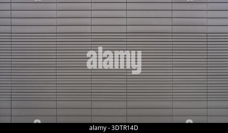 Gray cladding of an industrial facade with rectangular panels Stock Photo