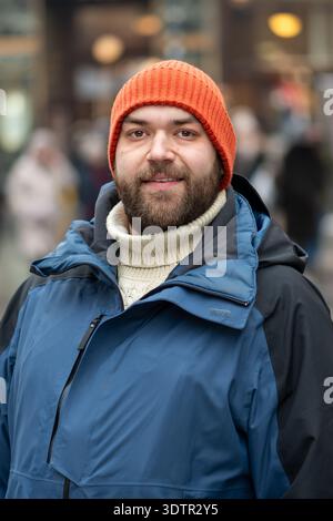 35 year old man standing on European city street in winter Stock Photo