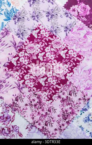 Fabric patchwork squares, in various colours and designs, stacked background backdrop. Sewing craft needlework concept. Stock Photo