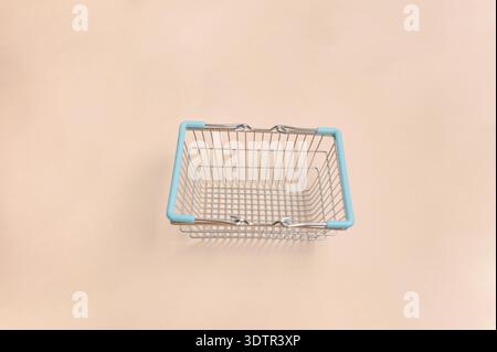 Turquoise Basket On Neutral Background. Empty Blue Shopping Basket With Wire Grid Design Stock Photo