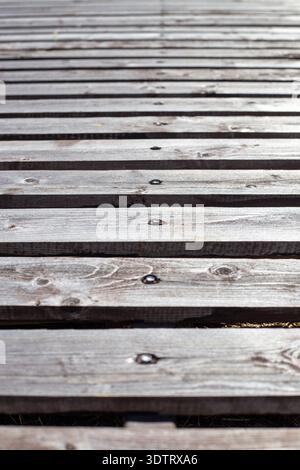 Vertical view of horizontal wooden planks with screws showing texture and grain. wood background, natural material, rustic surface. Stock Photo