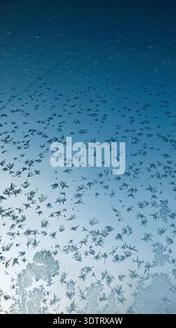 A Close-Up View of Intricate Ice Crystals Formed on a Window Pane, Reflecting Winter's Unique Beauty Stock Photo