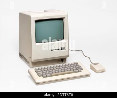 Beige vintage personal computer with keyboard and mouse from the 80s isolated on white background Stock Photo