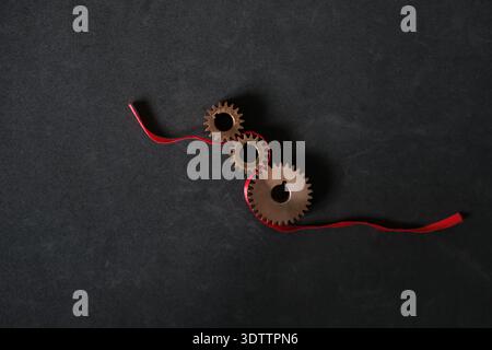 Business process connection and management concept with gears and red thread. Minimalism. Copy space. Stock Photo