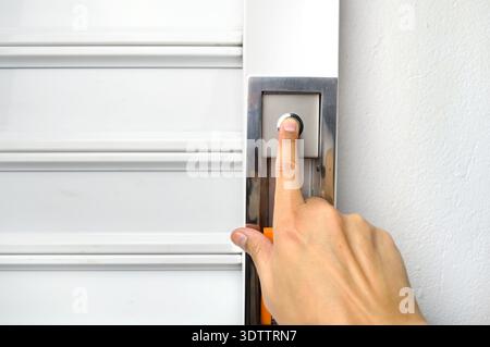 closeup of hand pushing the button to open the garage door Stock Photo