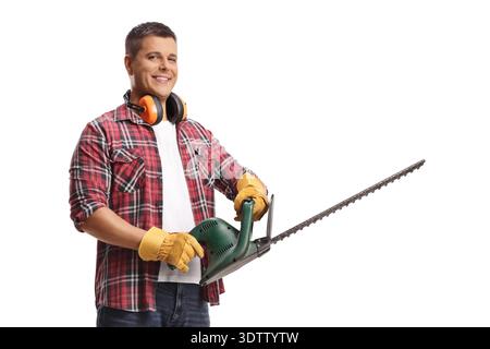 Young man with a chainsaw isolated on blue background Stock Photo