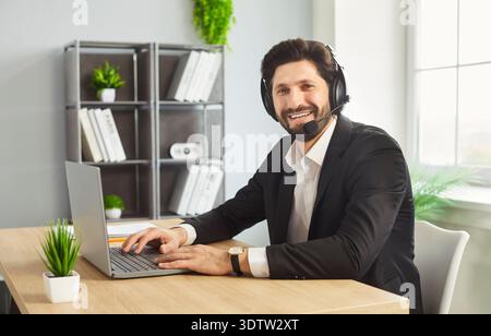Remote work of call center operator, customer support or businessman with headset in office Stock Photo