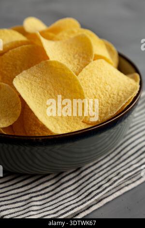 Sour Cream and Onion Flavored Chips in a Bowl, side view. Close-up. Stock Photo