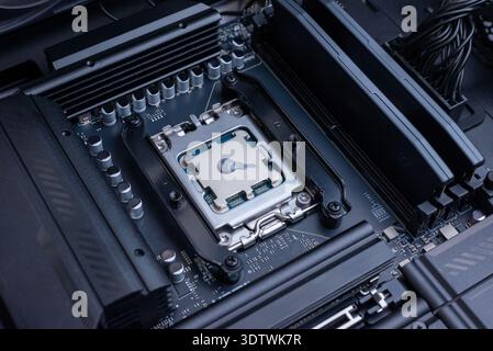 Desktop processor with applied thermal paste installed on motherboard socket, computer cooling preparation and high performance pc build concept Stock Photo