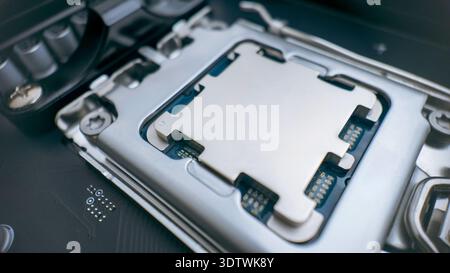 Modern desktop processor installed in motherboard socket, close up of cpu contact plate and high performance computer hardware technology concept Stock Photo