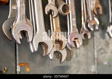 A detailed, close-up view of a selection of metal wrenches and spanners of various sizes, including some marked 'GERMANY' and with visible sizes like Stock Photo
