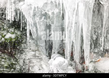 Icy enchantment unfolds, as nature's artistry sculpts ethereal formations. The crisp air whispers tales of winter's delicate embrace, a frozen masterp Stock Photo