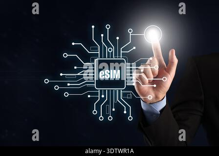 Businessman activating eSIM microchip on virtual screen, closeup. Black background Stock Photo