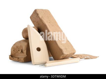 Pieces of clay and sculptor tools isolated on white background Stock Photo