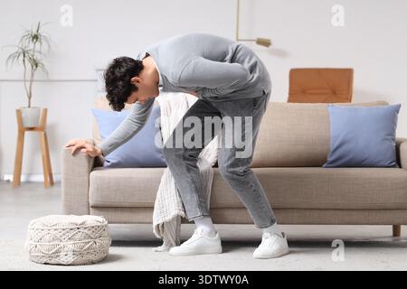 Young man having panic attack at home Stock Photo