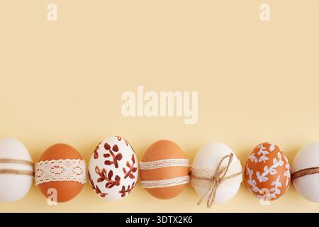 Composition with decorated Easter eggs on beige background Stock Photo
