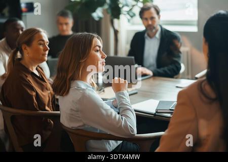 Team of corporate professionals attending group meeting at office Stock Photo