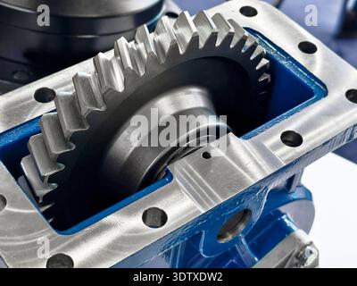 Close-up view of a metallic gear system showing detailed engineering in a machine workshop Stock Photo