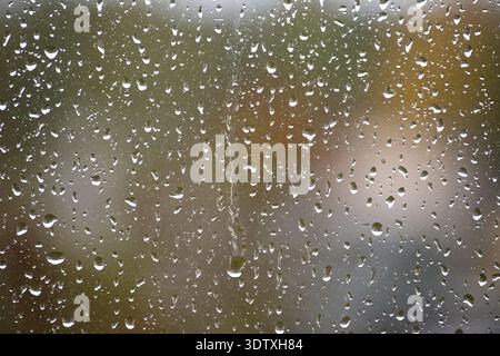 The raindrops create a mesmerizing pattern, offering a unique perspective on the world outside Stock Photo