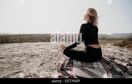 Woman Meditating on a Mountaintop Stock Photo