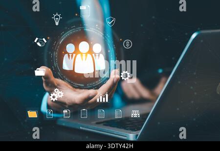 Businessman presenting HR management system on laptop. Concept of human resources, recruitment technology, digital workforce, and personnel management Stock Photo