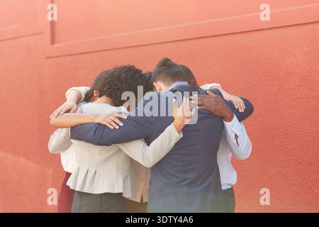 Motivation, business or people in circle with hug, collaboration or solidarity in teamwork. Support, together or employees in huddle with embrace Stock Photo