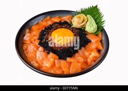 Premium salmon sashimi donburi featuring ikura salmon roe, caviar, and raw egg yolk, elegantly presented with wasabi and pickled ginger on a white bac Stock Photo
