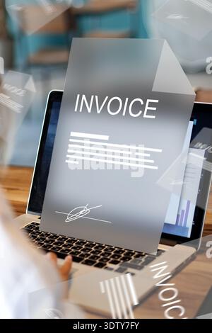 Banking invoice payment process on a laptop during daytime at a workspace Stock Photo