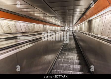 Empty subway escalator in underground metro station with perspective view Stock Photo