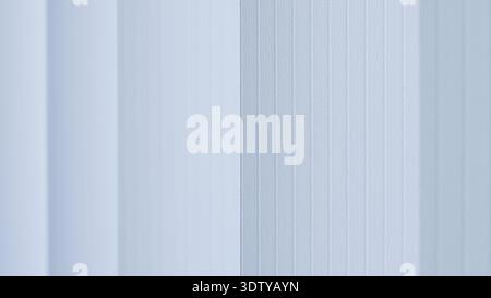 Close-up of textured white wall panels featuring vertical lines in a contemporary setting Stock Photo