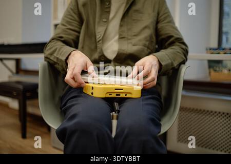 Middle Aged Man Using Assistive Device in Library Stock Photo